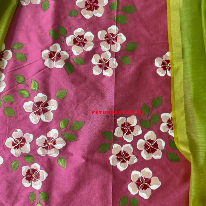 Vibrant floral motifs on hand-painted kurta and dupatta. Hand-painted floral motifs in bright colors on kurta and contrast dupatta.